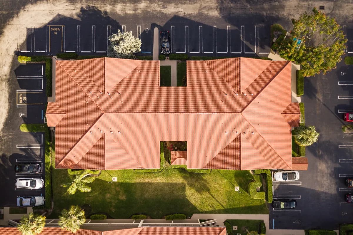 Aerial view of a condo building with a tile roof