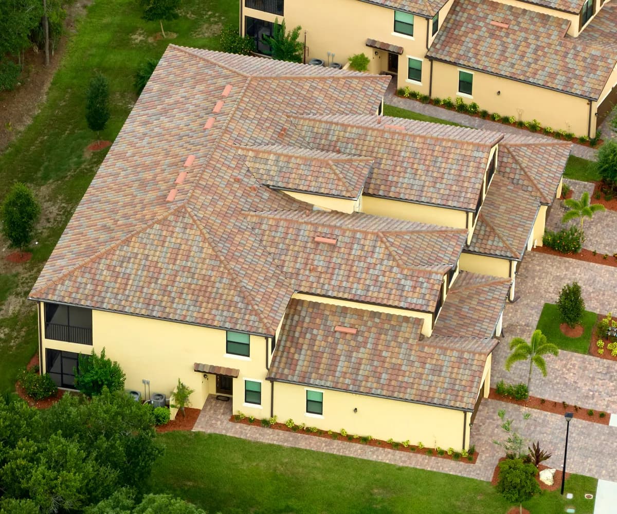 Aerial view of a townhome community with tile roofs
