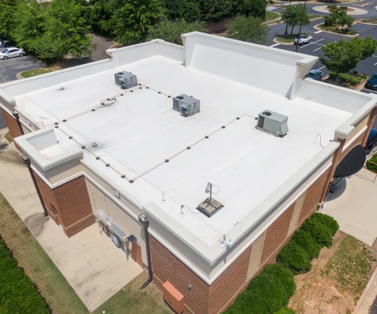 Aerial view of a white membrane flat roof with rooftop units
