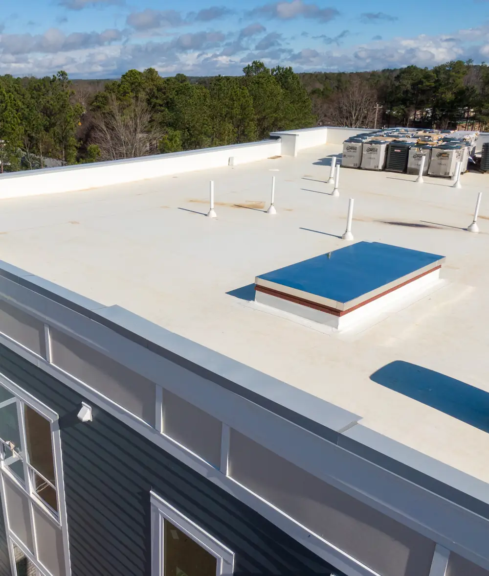 Commercial building with a white flat membrane roof and skylight