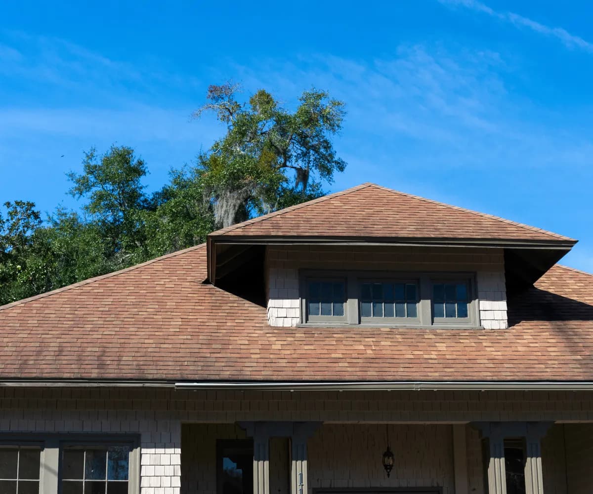 Craftsman bungalow with a shingle roof and dormer