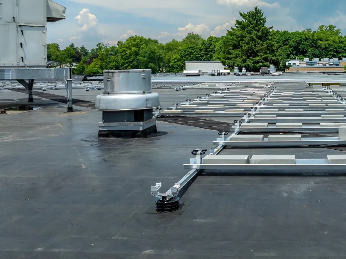 Black EPDM membrane on a commercial flat roof with rooftop units