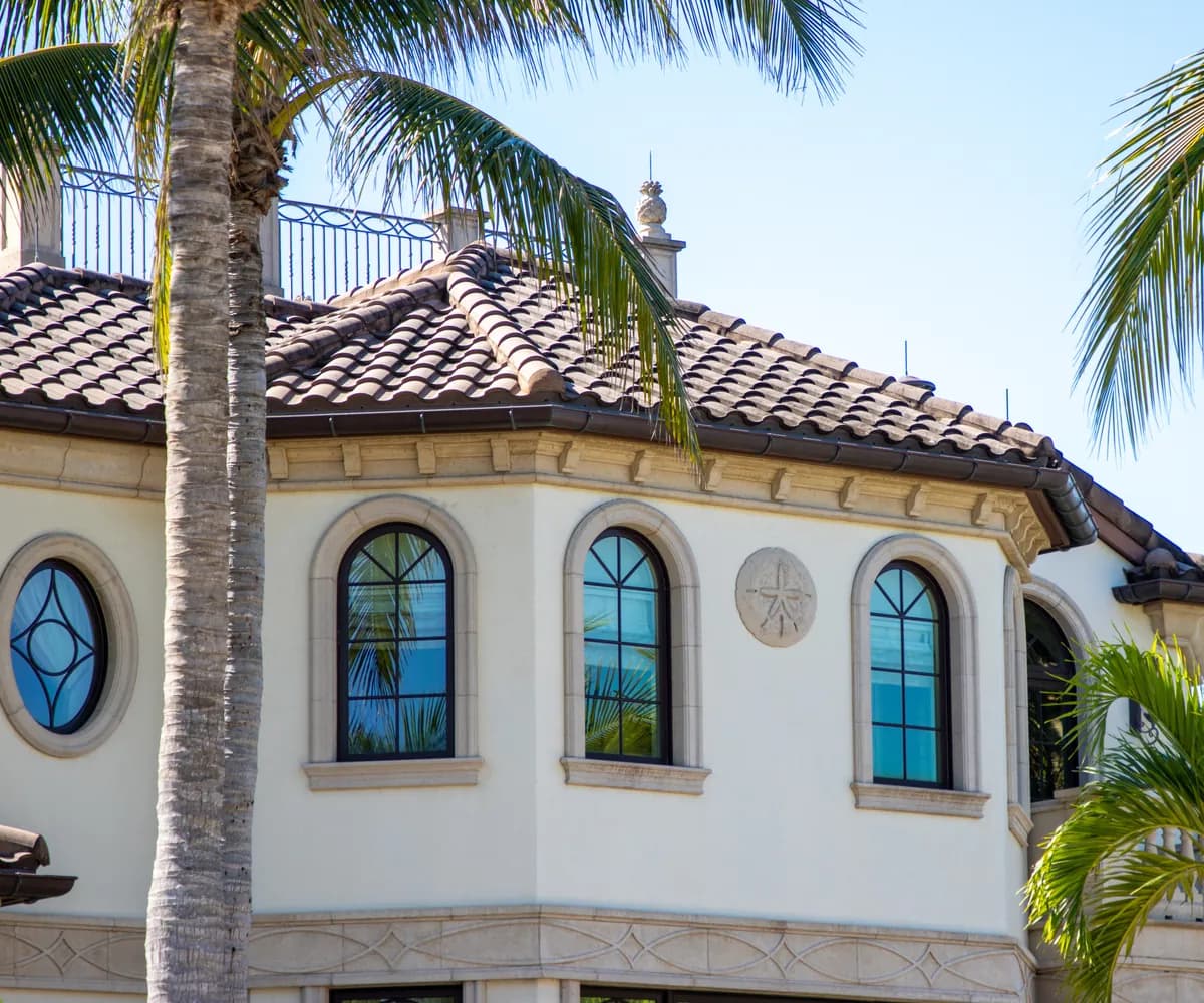 Mediterranean-style home with a tile roof and arched windows