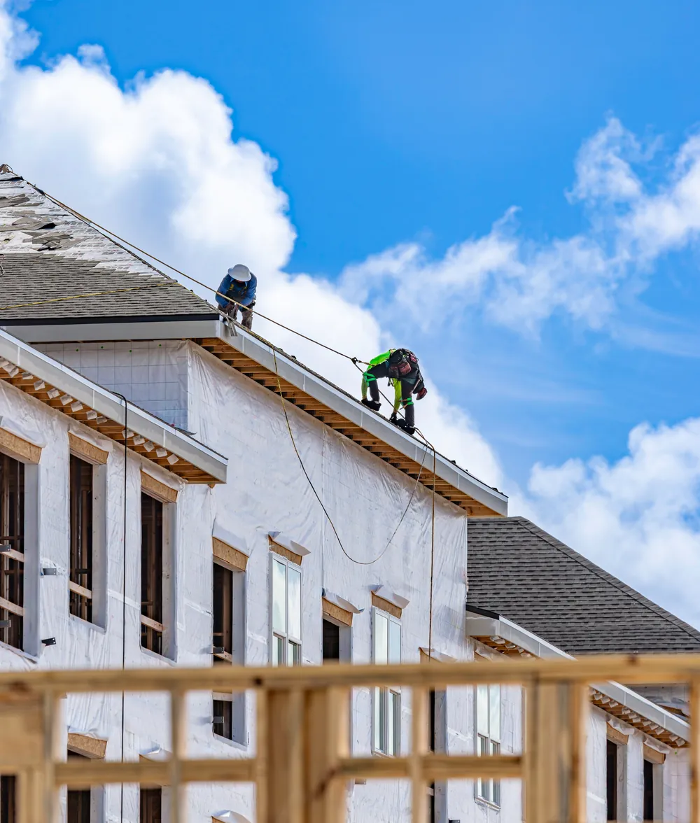 Roofers working on new homes under construction