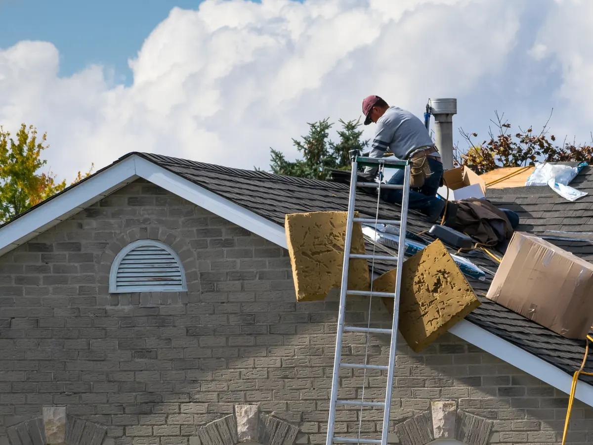Roofer installing a new shingle roof
