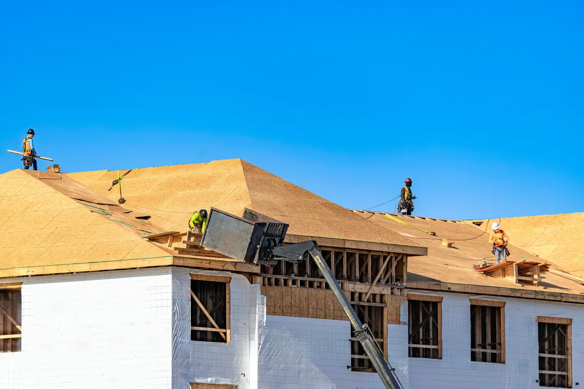 Roofing crew working on a large multi-family building